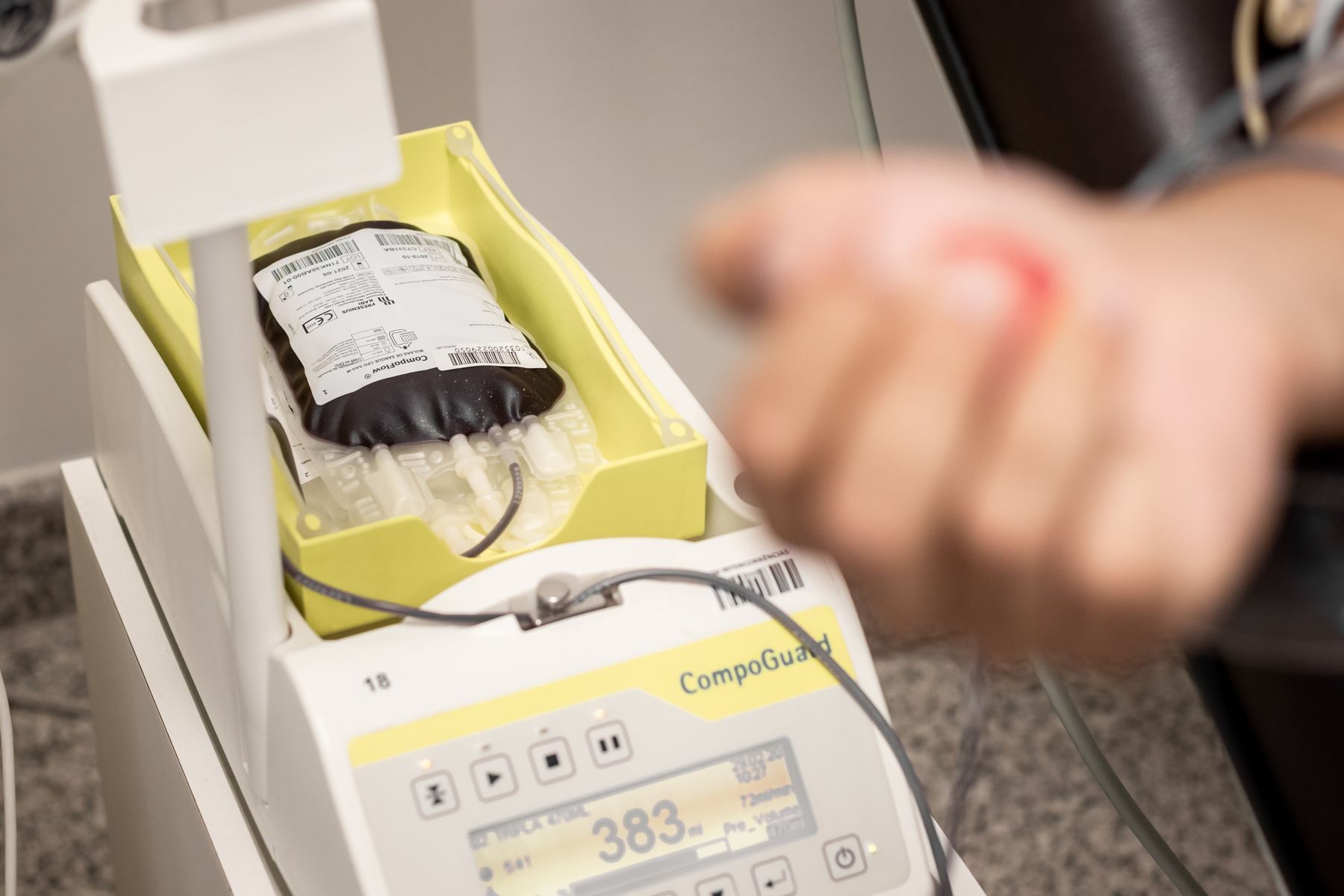 A blood bag on a collection monitor showing a numeric readout.